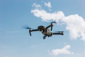 controlled modern drone flying in blue sky